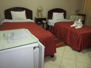 Postel nebo postele na pokoji v ubytování Hotel Suite Plaza