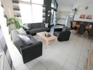 a large living room with couches and a table at Aquaronde 119 in Lemmer
