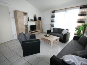 a living room with two couches and a tv at Aquaronde 119 in Lemmer