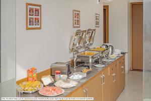a kitchen with a counter with food on it at Treebo Premium Tranquil Inn in Shimla