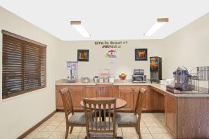 a kitchen with a table and chairs and a counter at Super 8 by Wyndham St. George UT in St. George