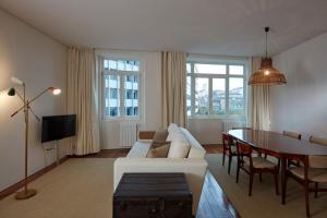 a living room with a white couch and a table at Casas do Rivoli in Porto