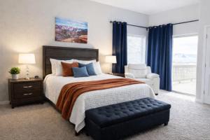 a bedroom with a bed and a chair and a window at Lake Powell Views and Prime Location in Page