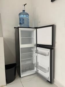 a refrigerator with a bottle of water on top of it at Consulado Santa Catarina a 2 min in Monterrey