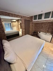 a bedroom with a large bed and a bath tub at Luxury Living Apartments and Spa in Thessaloniki