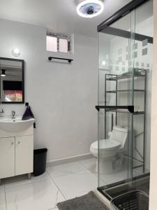 a bathroom with a toilet and a sink at Consulado Santa Catarina a 2 min in Monterrey +20 photos
