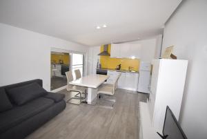 a kitchen and a living room with a table and a couch at Stars Palace - apartments and rooms in Jezera