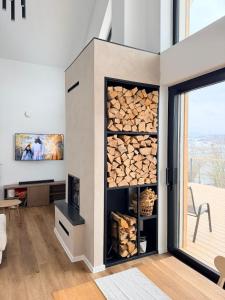a room with a wall filled with logs at Chalet Aria in Hyby