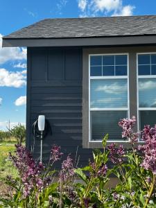 a house with purple flowers in front of it at 3 King Beds Spacious 4 BR 3 BATH AC Near Jackson in Victor
