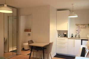 a small kitchen with a table and a bathroom at Studio for 2 people in Bouloc