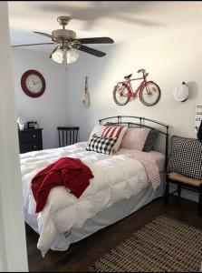 a bedroom with a bed with a bicycle on the wall at Waterfront with Heated Pool, Dock & Outdoor Fun ! in Beach Haven West +20 photos