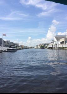 a view of a river with houses and a boat at Waterfront with Heated Pool, Dock & Outdoor Fun ! in Beach Haven West