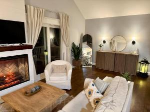 a living room with a couch and a fireplace at Waterfront with Heated Pool, Dock & Outdoor Fun ! in Beach Haven West