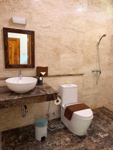 a bathroom with a toilet and a sink and a mirror at Baan Yanikar in Lampang +7 photos