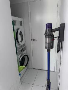 a machine in a laundry room with a washing machine at Mediterranean Studio & Garden View Private Pet Friendly in Brisbane +7 photos