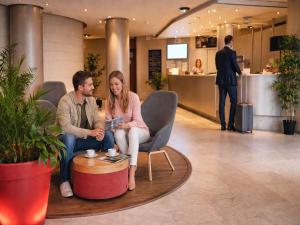 a man and woman sitting in a chair in a lobby at Mercure Port La Grande Motte in La Grande Motte +85 photos