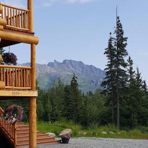 a porch of a cabin with a view of a mountain at Alaska Knotty Pine Whole Building in Palmer