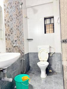 a bathroom with a toilet and a sink at Saichha Guest House in Calangute