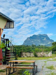 a picnic table with a view of a mountain at Thung Setthi Homestay&Cafe4 in Chiang Dao