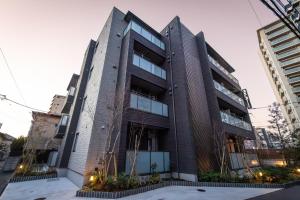 an apartment building in a city with tall buildings at ReLA Kashiwa Eki Mae in Kashiwa