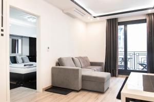 a living room with a couch and a bed at Luxe Central Apartments in Budapest