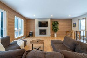 a living room with a couch and a fireplace at Foosball table Spa & Sauna - Sommetoile in Saint Come