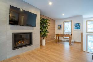 a living room with a fireplace with a flat screen tv at Foosball table Spa & Sauna - Sommetoile in Saint Come +61 photos