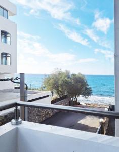 a balcony with a view of the ocean at Blue wave in Ierapetra