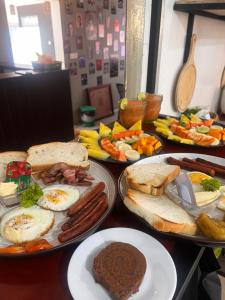 a table with plates of breakfast food on it at Ella Ceylon Homies Hostel in Ella
