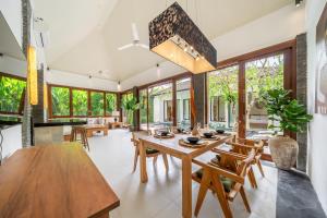 a dining room with a wooden table and chairs at Mimosa - Private Pool Escape with Panoramic Views in Kerobokan