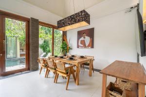 a dining room with a wooden table and chairs at Mimosa - Private Pool Escape with Panoramic Views in Kerobokan