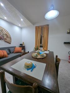 a living room with a table and a couch at DaLu' tourist accommodation in Vallerano