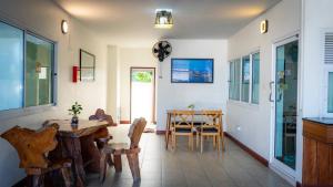 a living room with a table and a dining room at Saksiri apartment in Ban Si Than