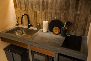 a kitchen counter with a sink and a candle at 燈やー弐 in Kyoto +20 photos
