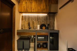 a kitchen with a sink and a microwave at 燈やー弐 in Kyoto
