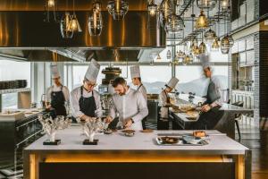 a group of chefs in a kitchen preparing food at Mandarin Oriental, Shenzhen in Shenzhen +166 photos