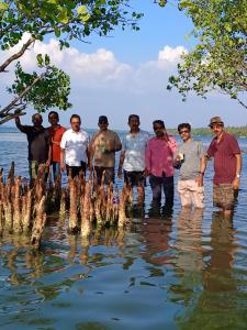 a group of people standing in the water at Lagoon celebration10 in Perumanseri