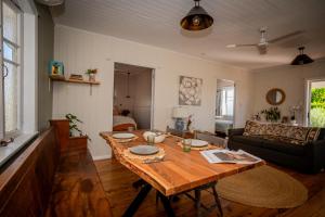 a living room with a wooden table and a couch at Herbgully Cottage in Roma +10 photos