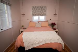 a bedroom with a large bed in a room at Herbgully Cottage in Roma