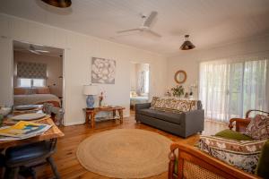 a living room with a couch and a table at Herbgully Cottage in Roma