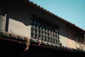 a building with a window on the side of it at 燈やー弐 in Kyoto
