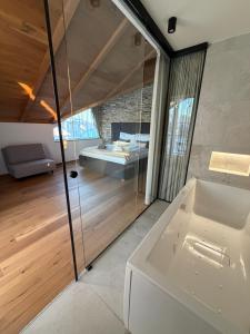 a bathroom with a tub and a bed in a room at Vila Vento in Veľký Slavkov +93 photos