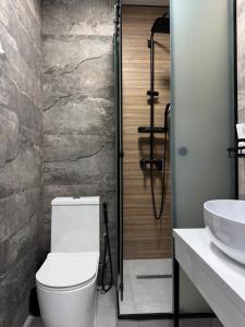 a bathroom with a toilet and a sink at Grey Hotel in Oral +24 photos