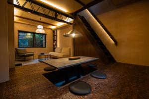 a living room with a table and a couch at 燈やー弐 in Kyoto