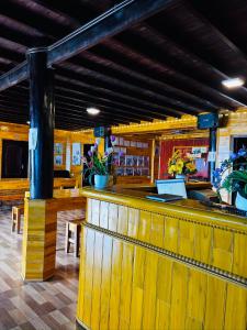 a bar in a restaurant with wooden walls at Sisi House Experience Hike & Batik Painting in Sa Pả