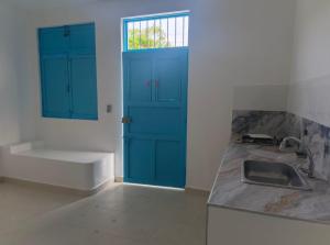 a kitchen with blue cabinets and a sink and a tub at Casa Barcelona in Honda +15 photos
