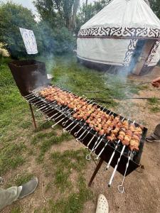 a grill with a bunch of food on it at Guest house Aidyn-Kul in Toguz-Bulak