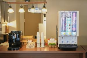 a coffee maker sitting on a counter with boxes at Nplus HOTEL Higashikanda-akihabara in Tokyo