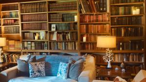 a living room with a couch in front of book shelves at The Farm in Whangaruru