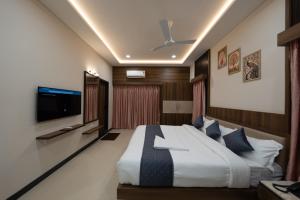 a bedroom with a large bed and a tv at Le Sea Sun in Pūrnānkuppam